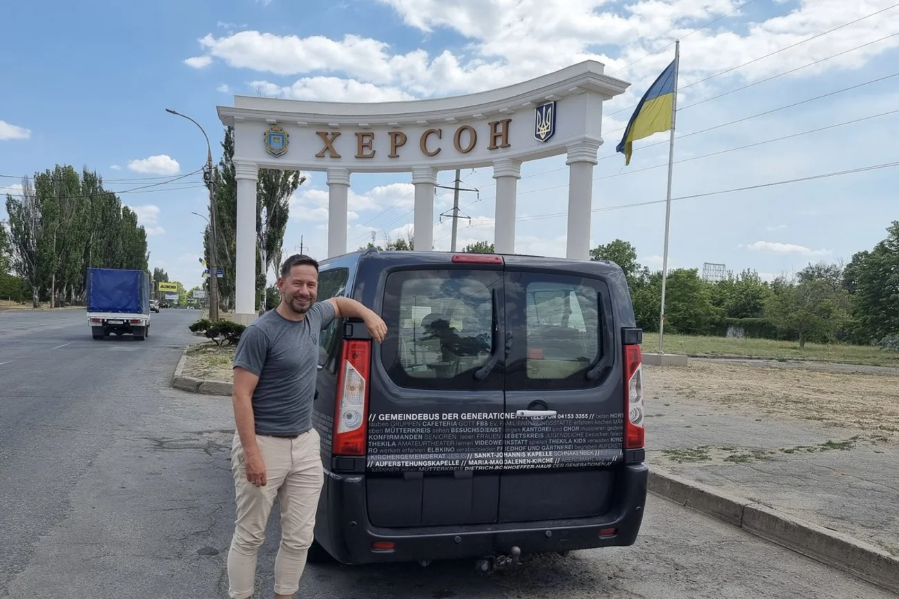 Ein Mann steht vor einem Transporter