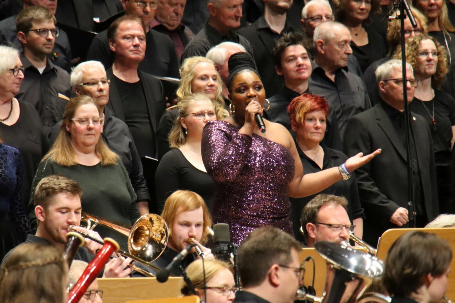Eine Sängerin steht inmitten eines Chores.