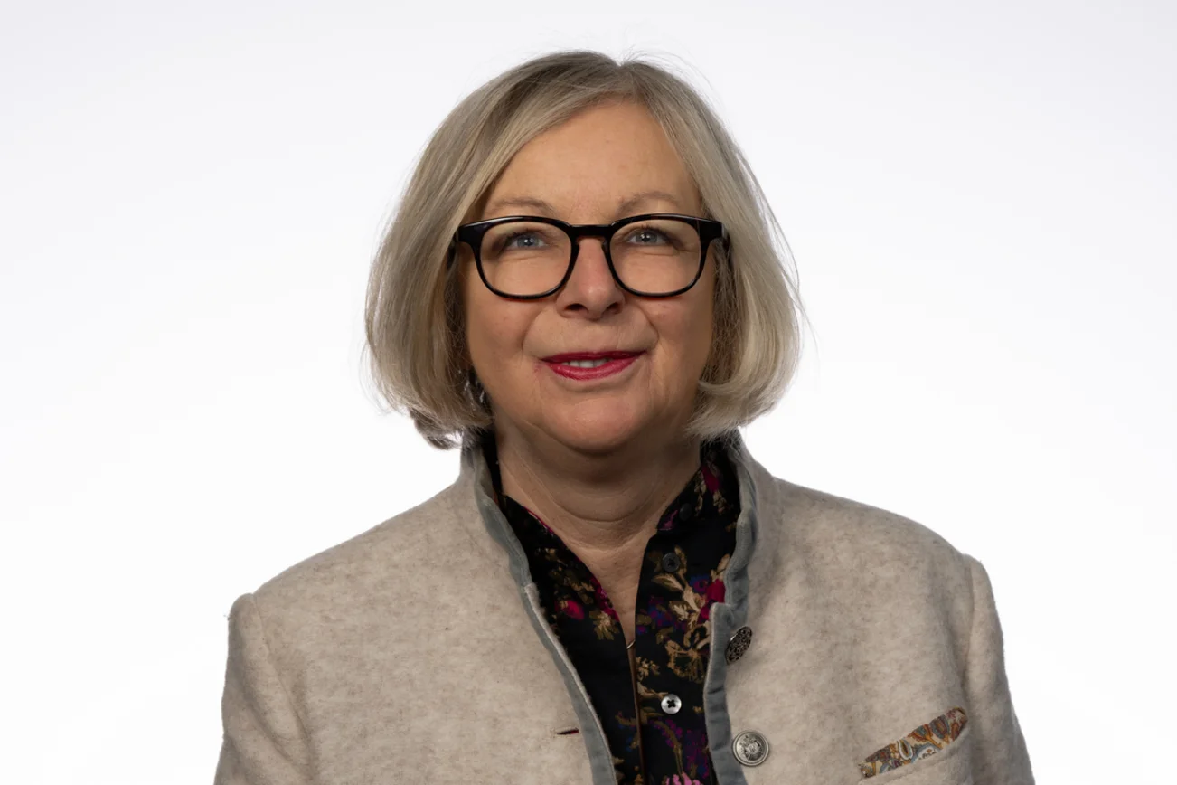 Frau mit Brille lächelt in die Kamera