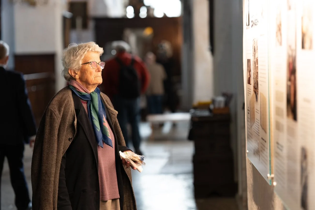 Frau betrachtet eine Gedenktafel