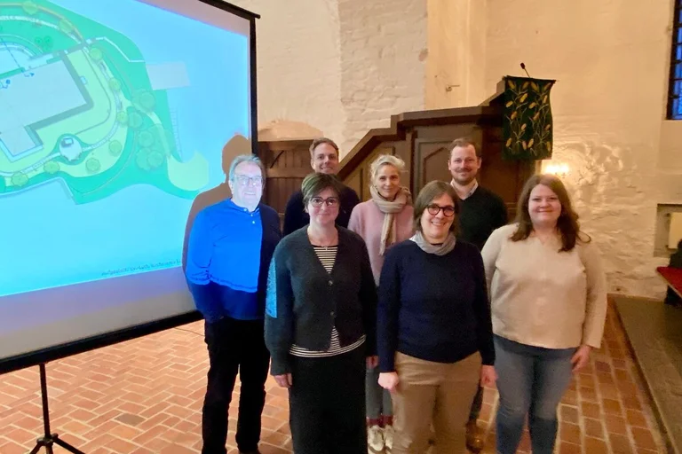 Gruppe von Personen vor Beamer-Leinwand